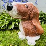 Ceramic Dog Sculpture in brown and white with a black nose and whiskers.