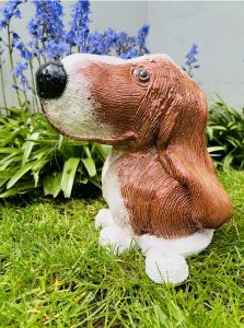Ceramic Dog Sculpture in brown and white with a black nose and whiskers.